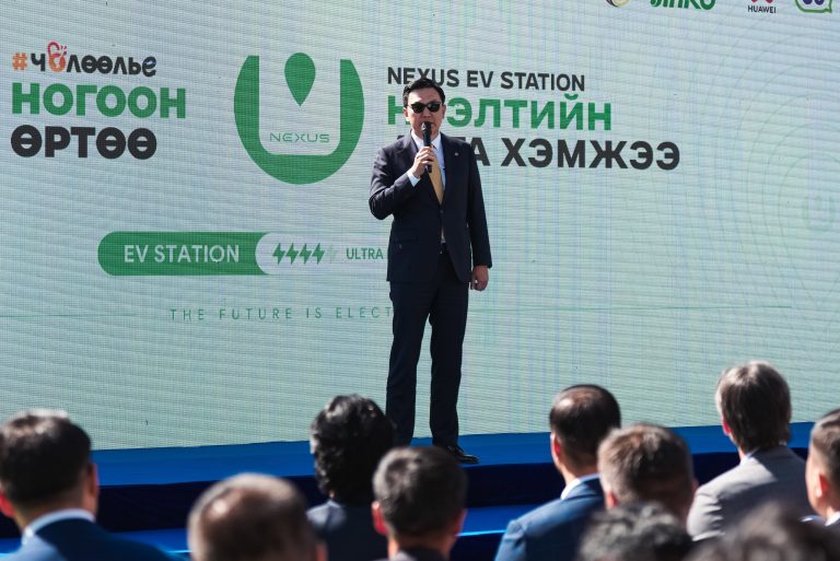 A speaker on stage at the NEXUS EV Station launch
