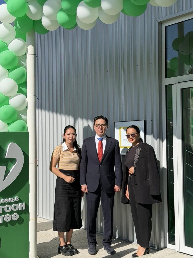 Three guests at the entrance of the NEXUS EV Station on opening day