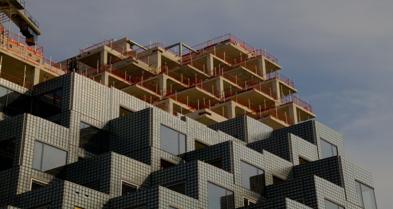 Industrial facility with emissions stacks, illustrating carbon capture technology in the built environment